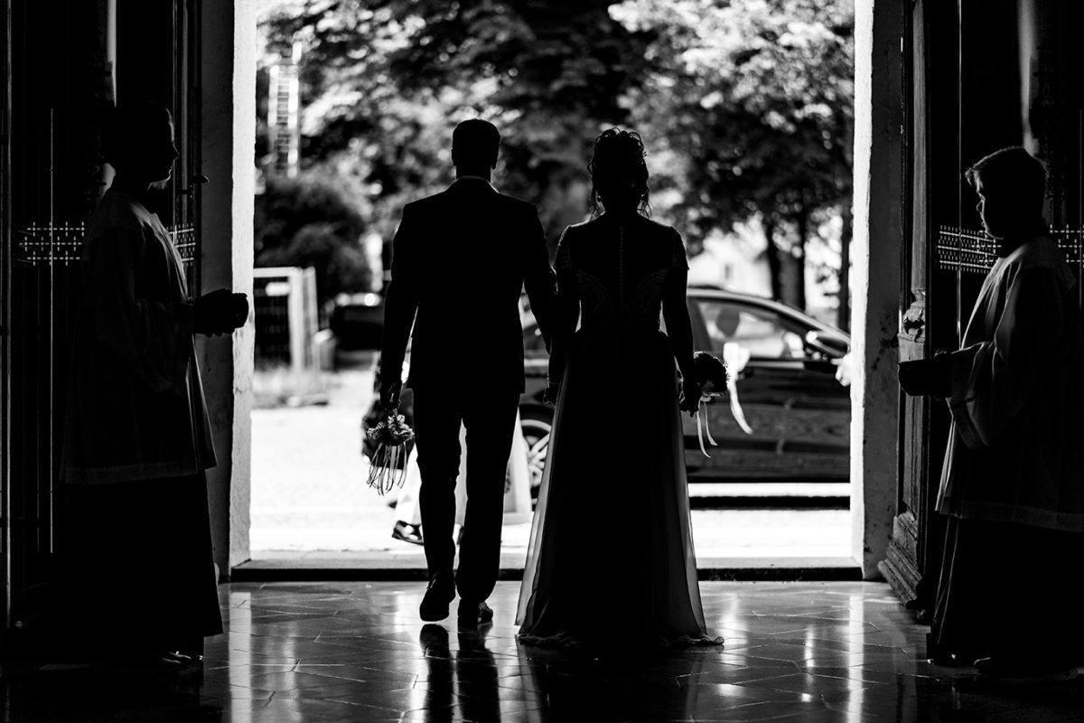 Bride and groom getting out of the church